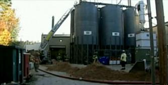 Fire fighters work to put out a massive blaze caused by a destructive combustible dust fire and explosion at the New England Wood Pellet Company's Jaffrey, NH facility. 