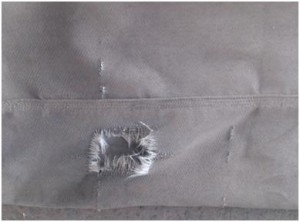 Rip in a baghouse filter caused by a broken support cage