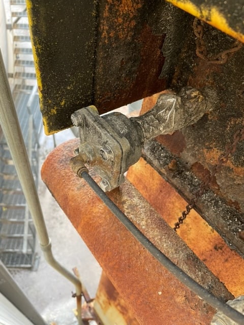 Taped up pulse valve connecting tube indicating likely air leak location in a pulse-cleaning system